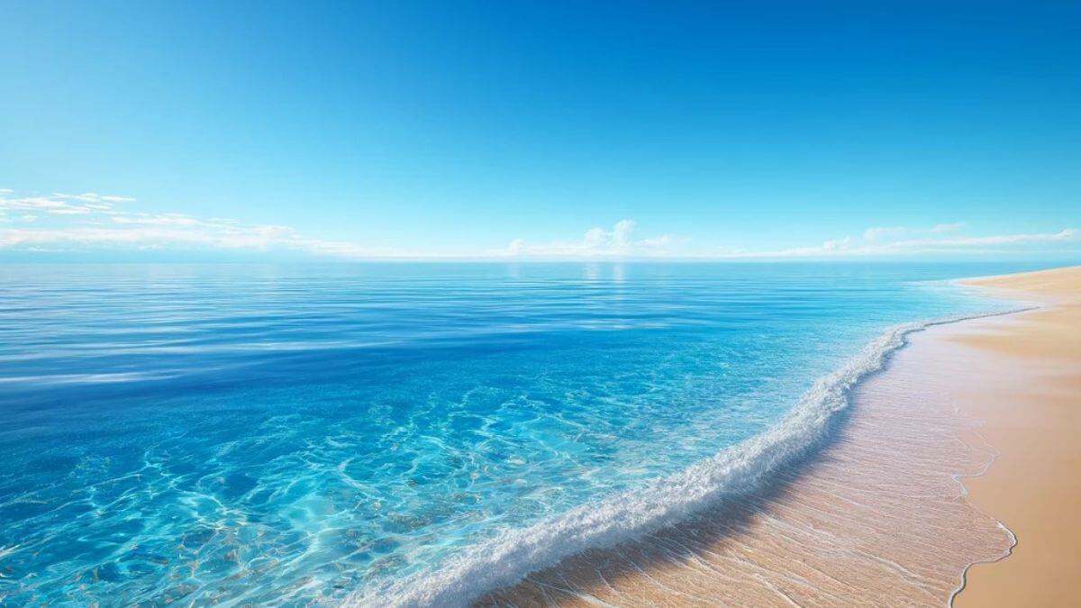 A pristine beach with crystal clear water under a bright blue sky, creating a serene and inviting scene.